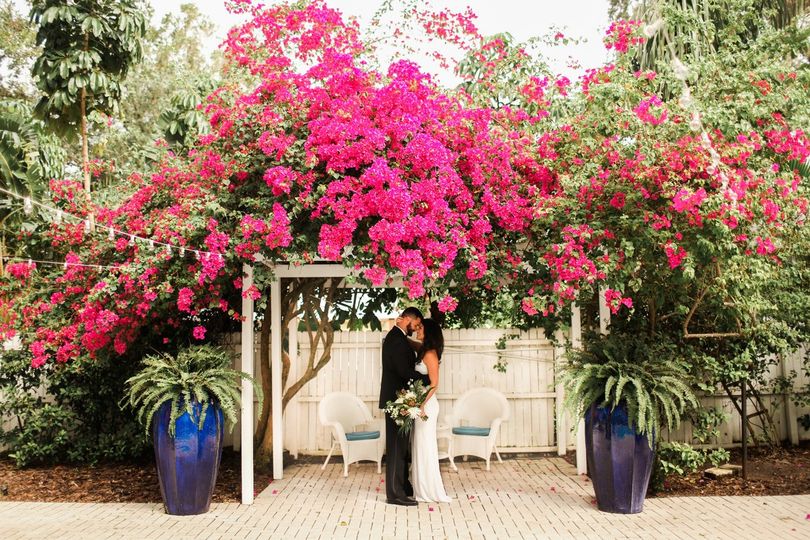 Wedding couple at altar under flowers